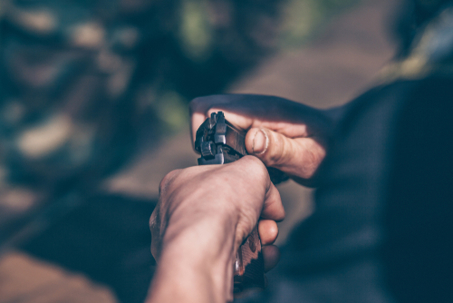Close up of a man's hands holding a firearm.